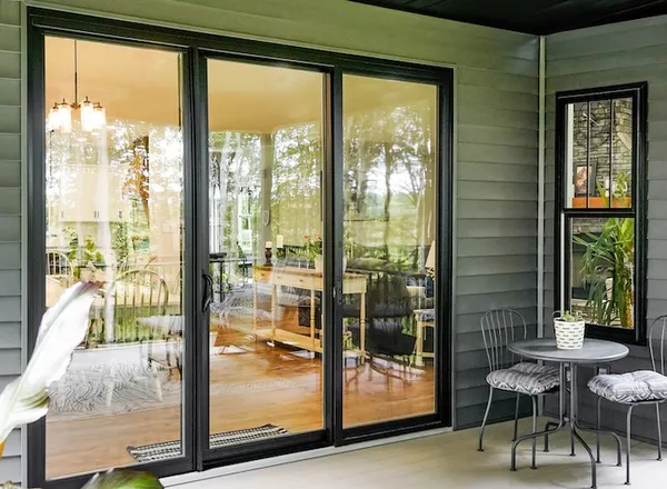 Three-panel sliding patio door opening onto a screened porch