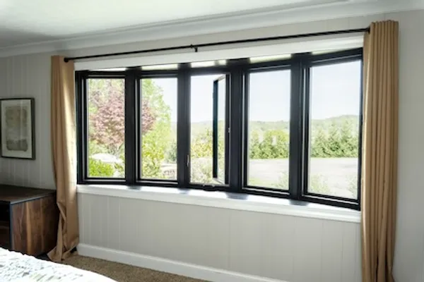 Interior view of a black bow window in a bedroom