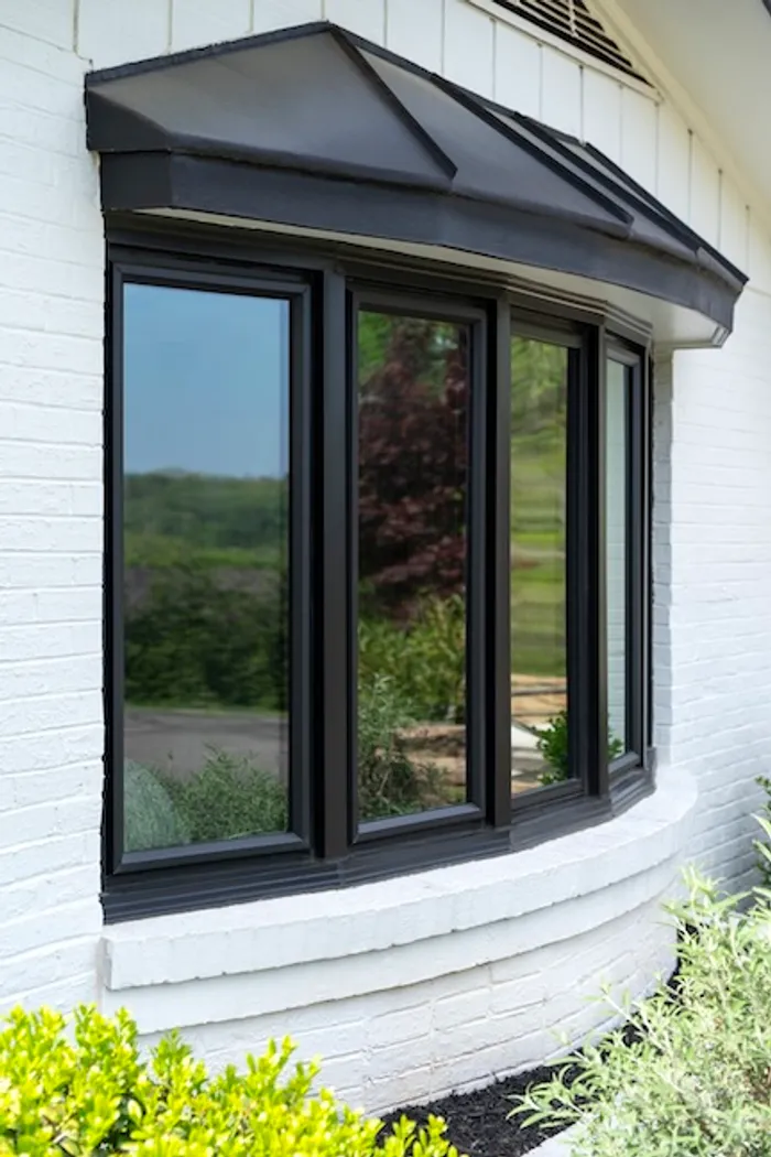 Exterior of a bow window with a copper-topped roof accent