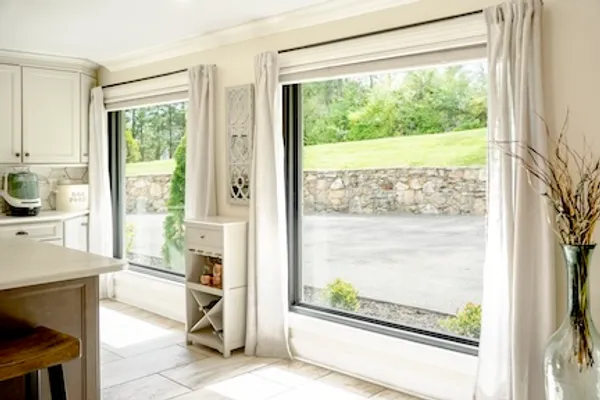 Large fixed picture windows in a kitchen dining nook