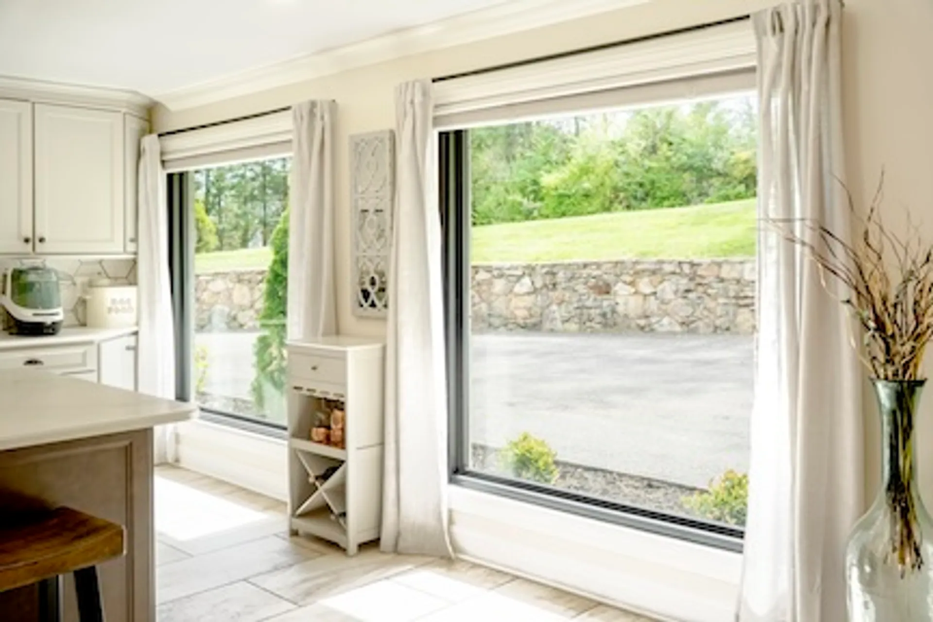 Large fixed picture windows in a kitchen dining nook