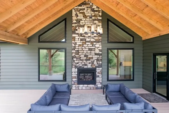 Shaped gable windows above picture windows on a covered patio