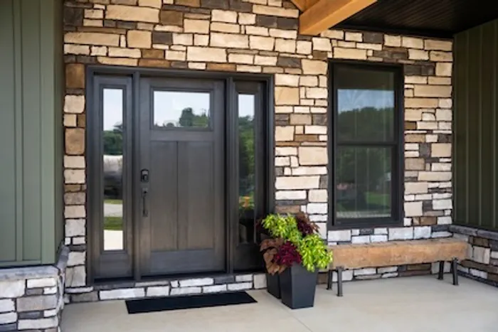 Single entry door with sidelites on a stone facade