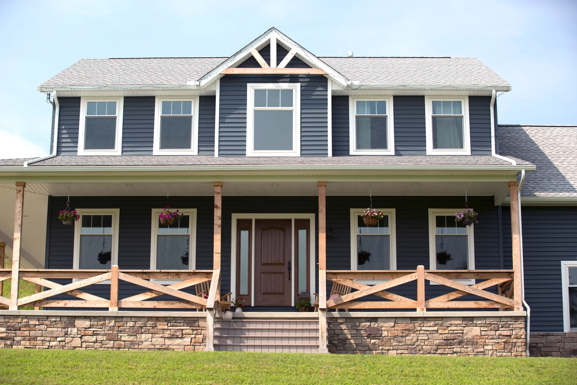 Navy farmhouse exterior with a welcoming front porch