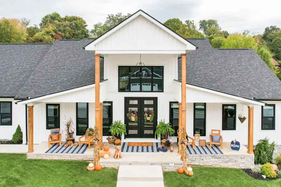 White farmhouse exterior with a black front door